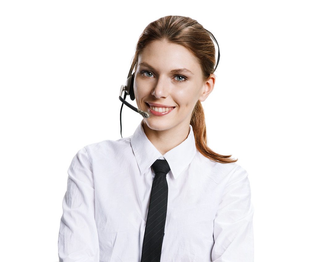 A customer service call center worker wearing a headset while working at a computer