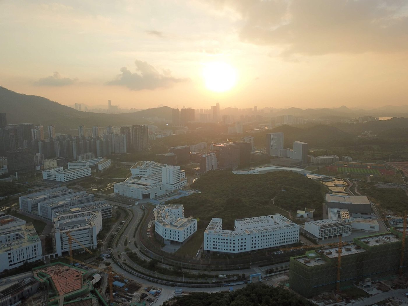 Aerial view of a Chinese university campus with buildings, paths, and green lawns