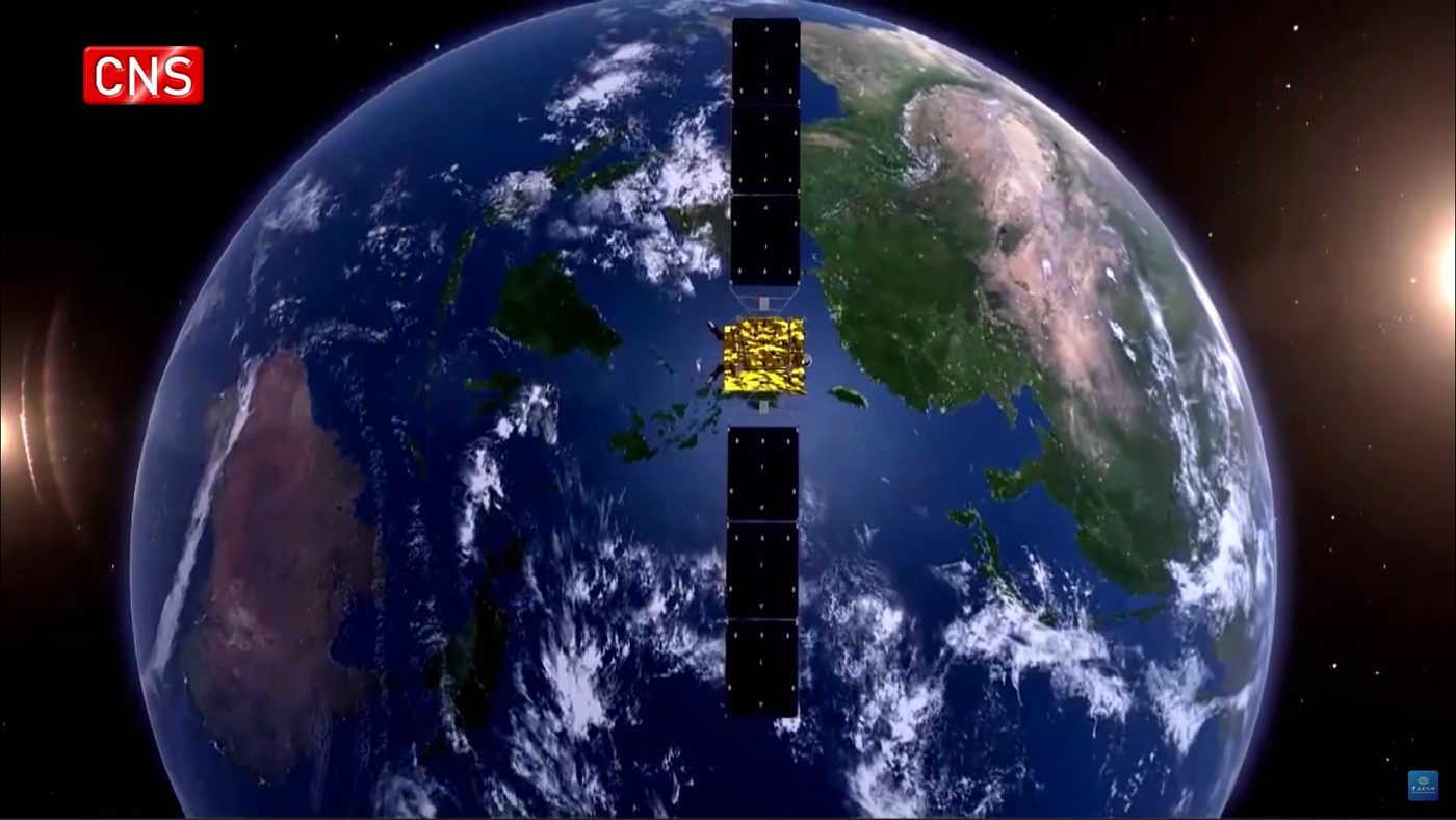 An artist's rendering of a BeiDou navigation satellite orbiting above Earth, its solar panels extended against a starry black sky.