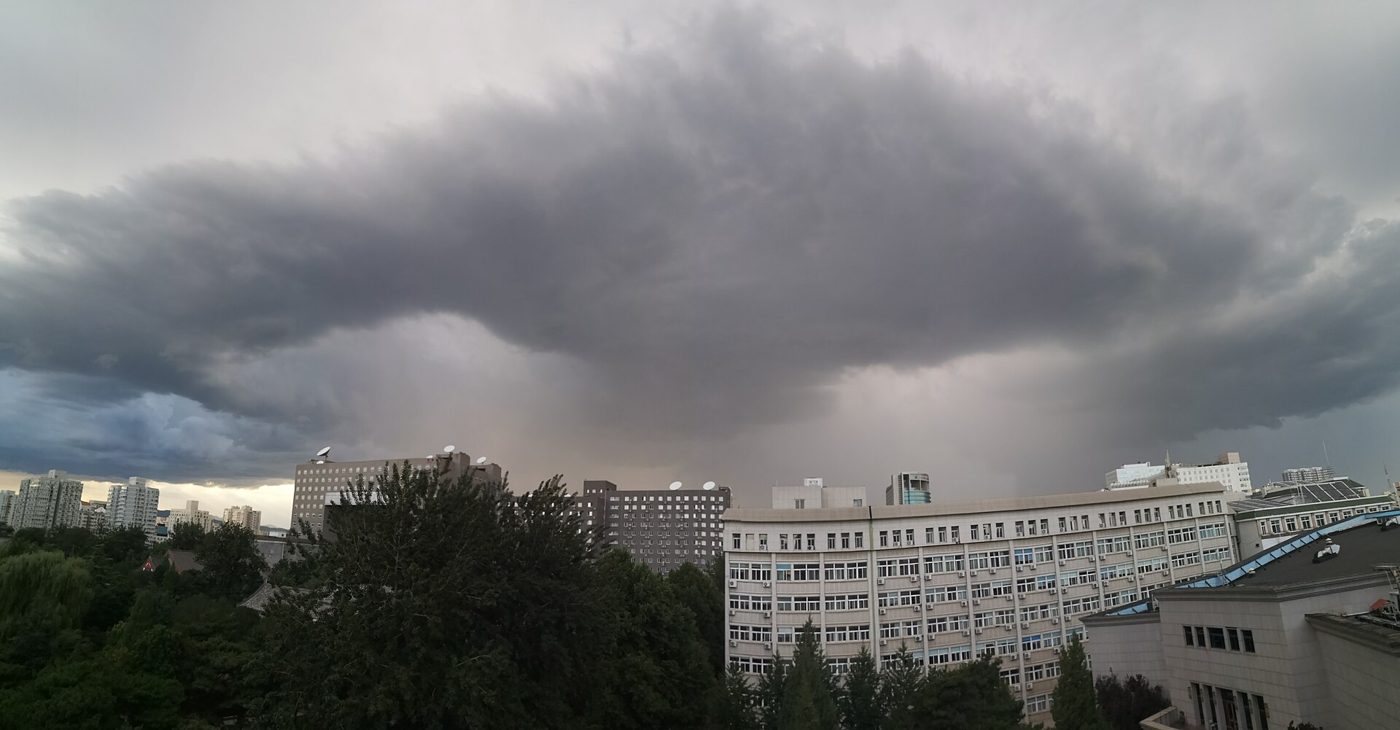 Overcast gray skies hang low over Beijing's rooftops, a visual sign of the heavy rain moving in.