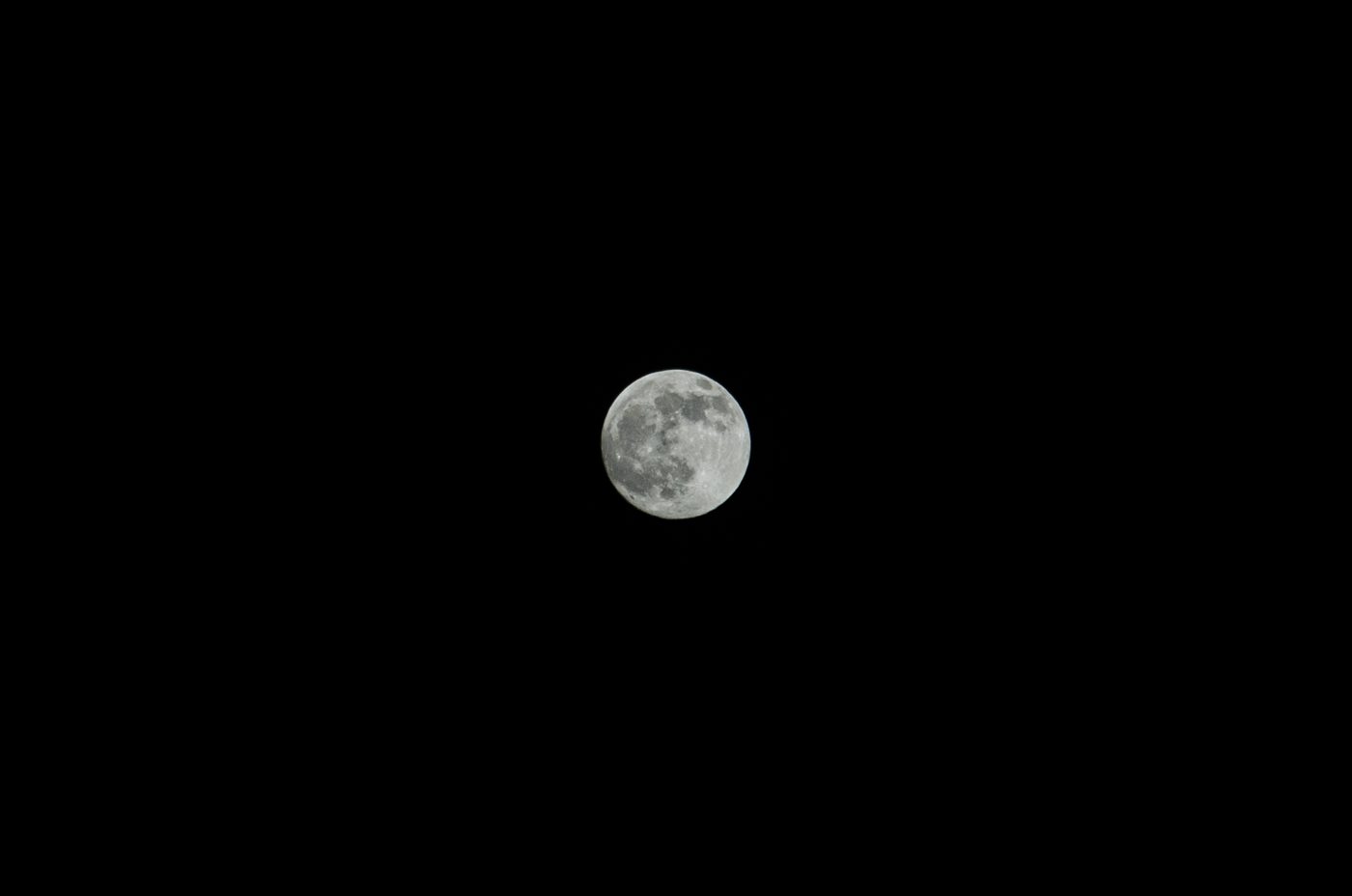 A bright full moon glowing in a dark night sky, photographed on Mid-Autumn Festival in China.