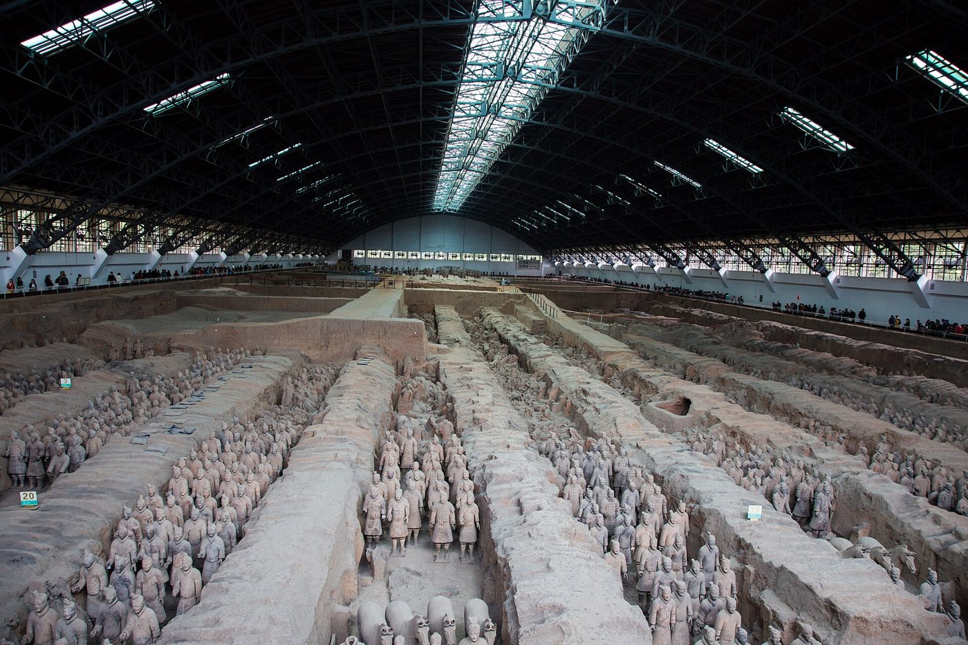 Rows of life-size terracotta soldiers standing in the excavated earthen trenches of Pit 1 at the Terracotta Army site near Xi'an