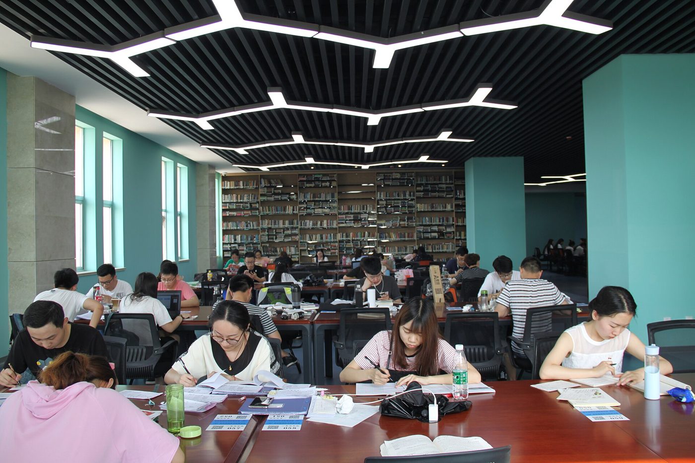 Students working at long tables in a Chinese university library