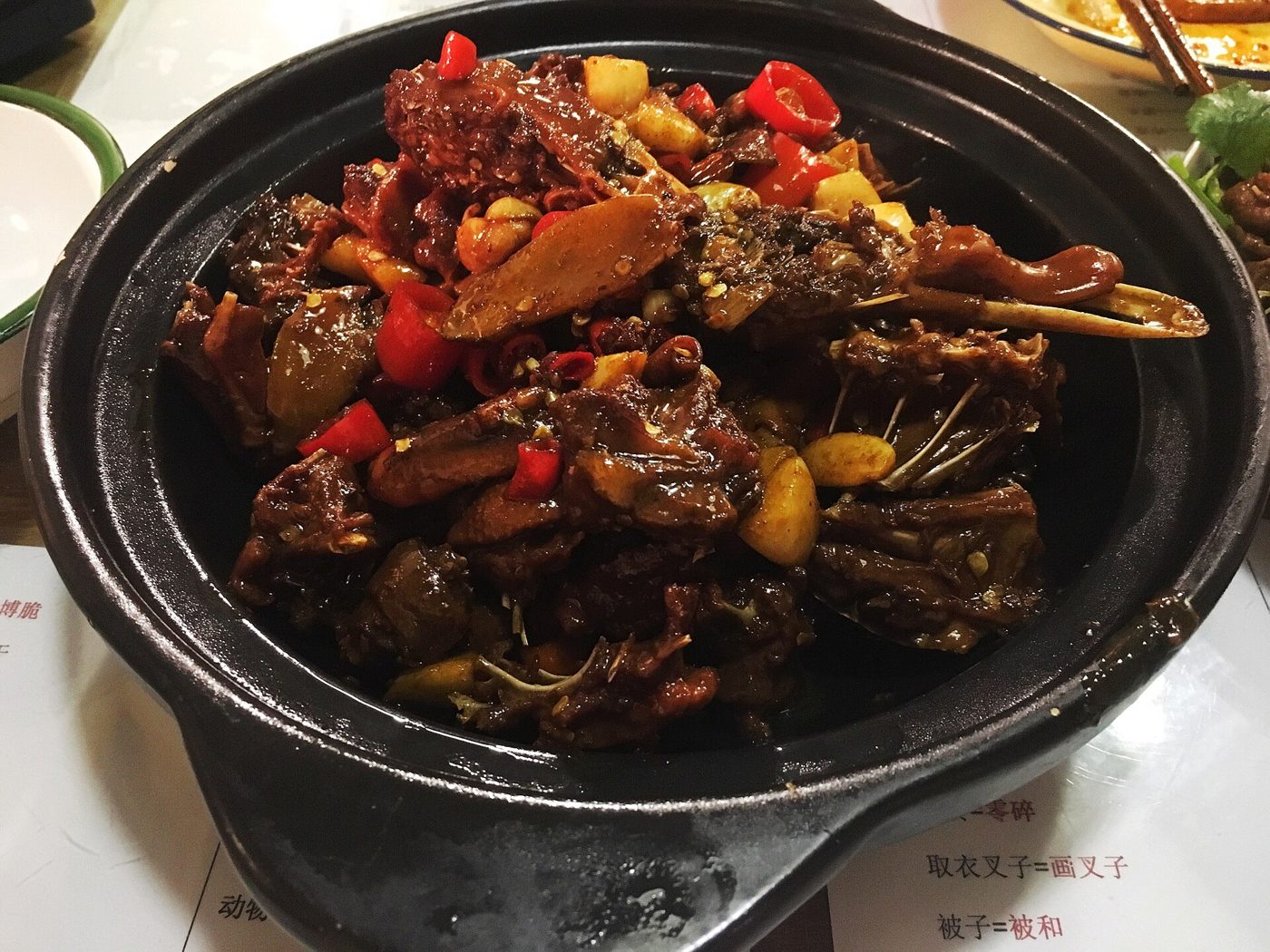 A plate of Jiangxi-style duck stewed in beer, dark and glossy with sauce.
