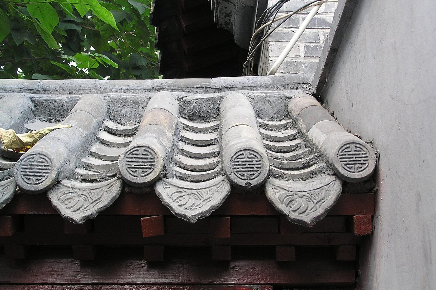 Close-up of overlapping gray tiled roof of a traditional hutong house in Beijing