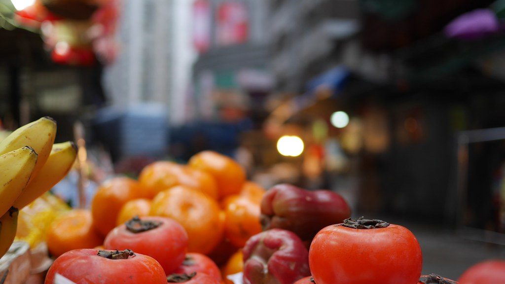 Persimmons displayed for sale at a fruit market stall in Hong Kong