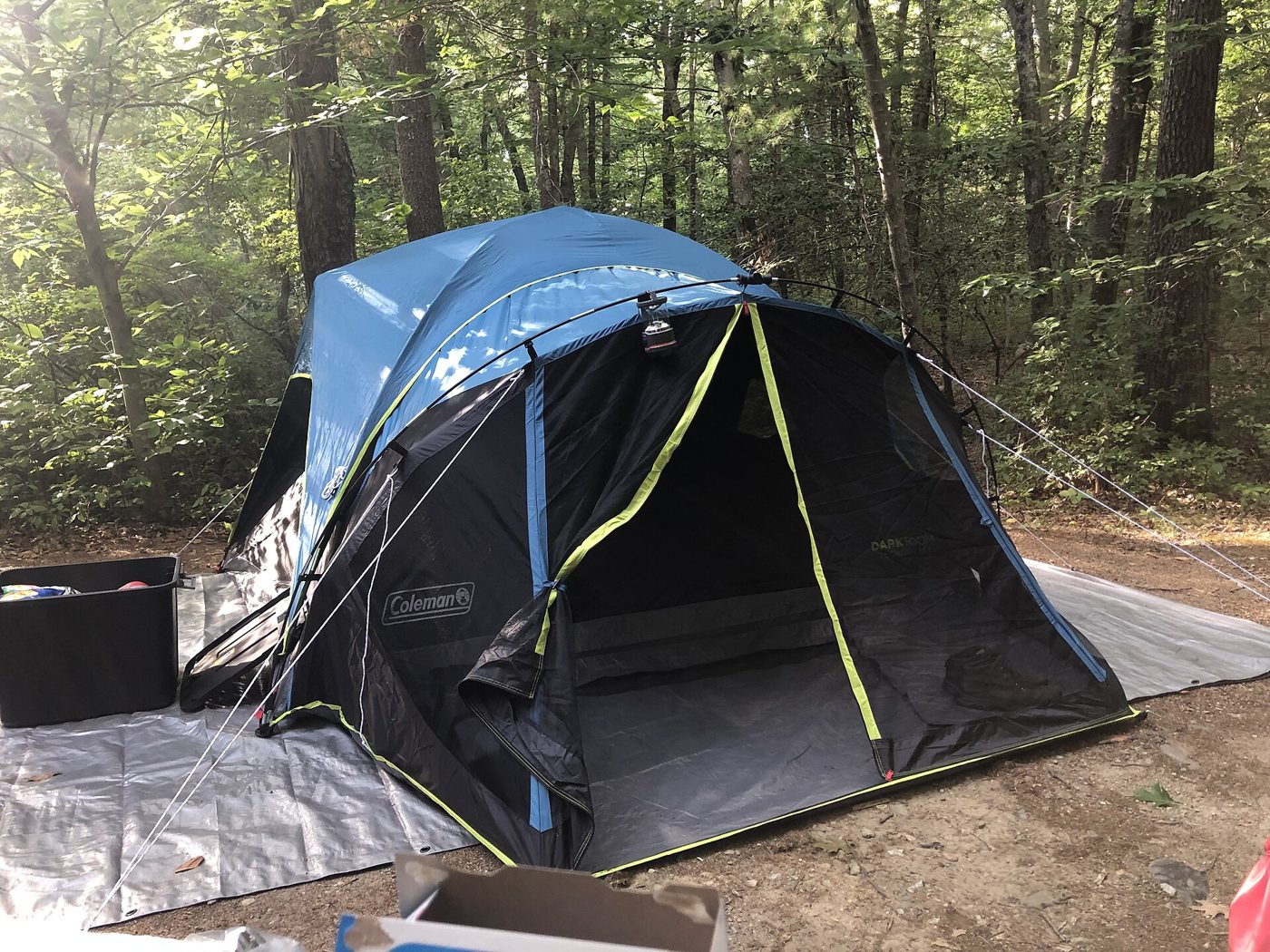 A camping tent pitched outdoors on a tarp, the kind of gear young travelers are buying instead of booking hotel rooms