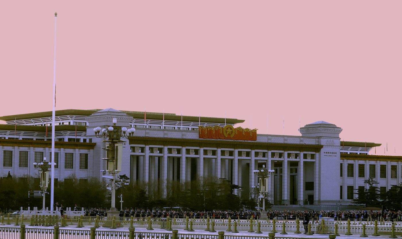 The five-star red flag rising above a crowd gathered at Tiananmen Square for the National Day flag-raising ceremony in Beijing.