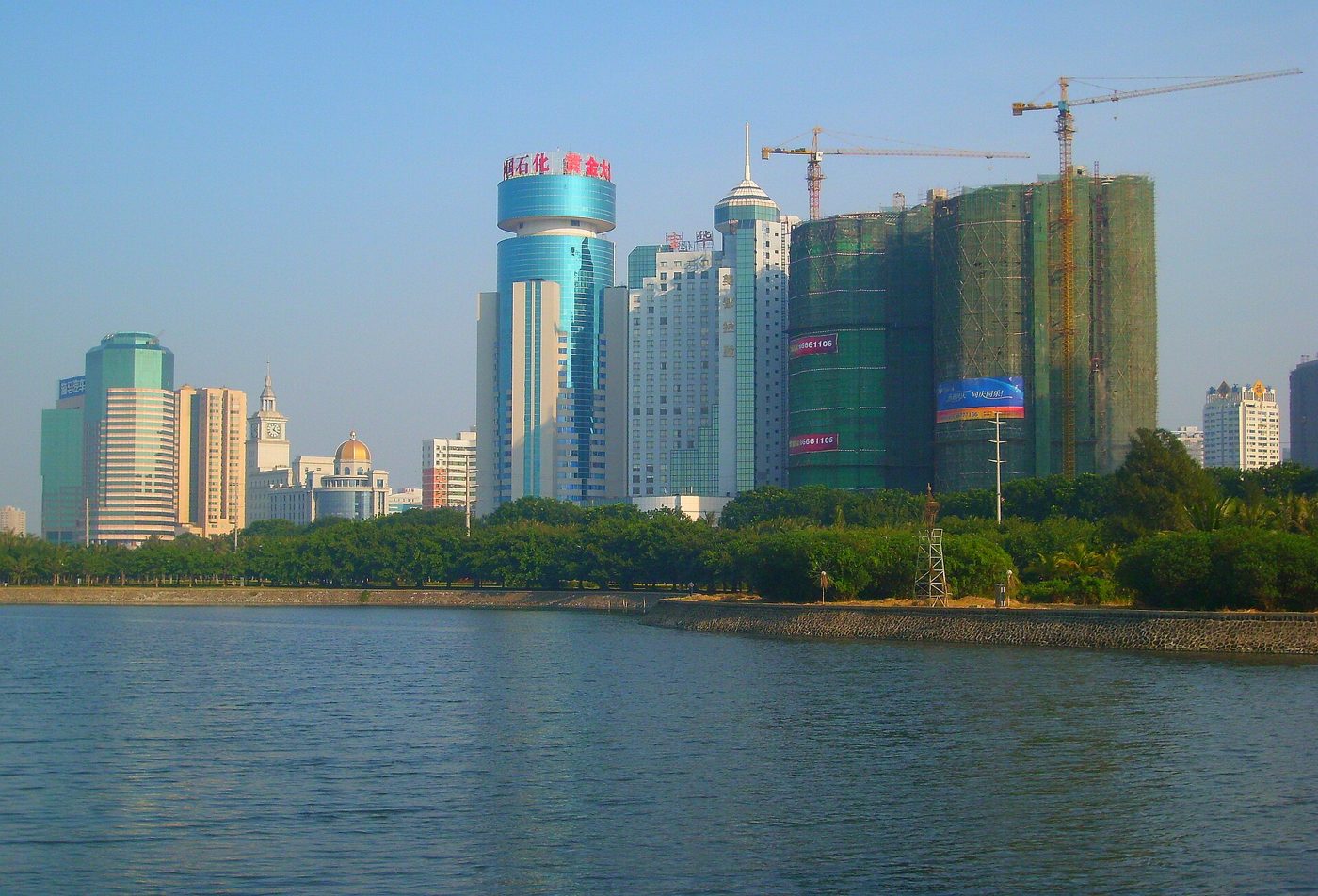 Skyline of Haikou, the Hainan capital city where the education forum was held, viewed across the water with modern high-rises along the shoreline