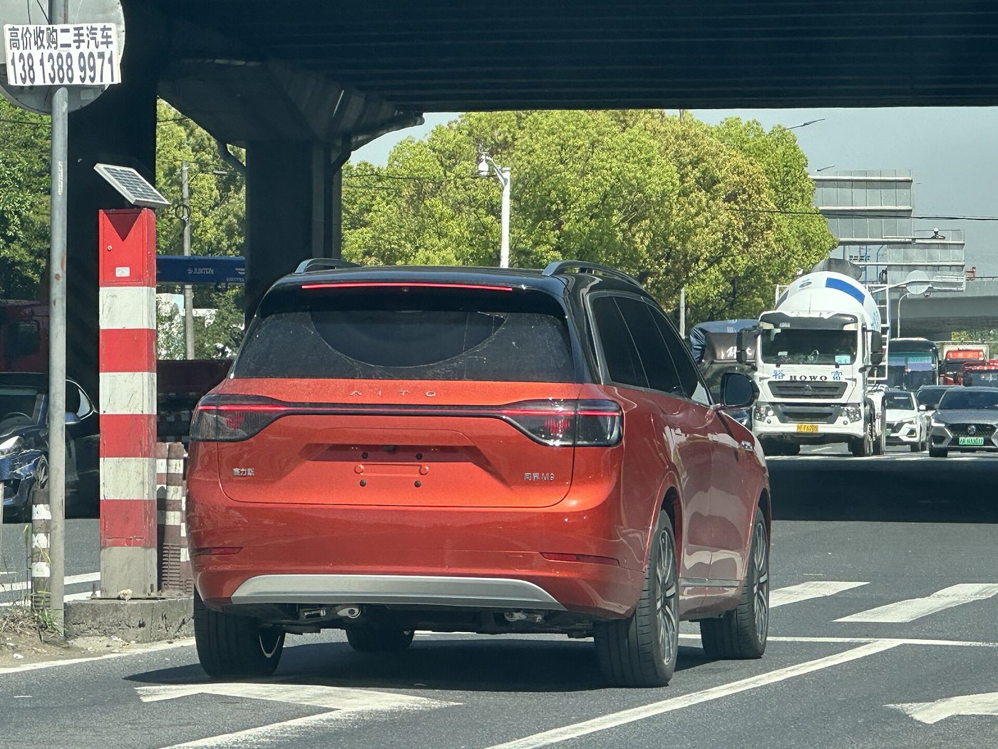 A white AITO (Wenjie) M9 electric SUV on display indoors