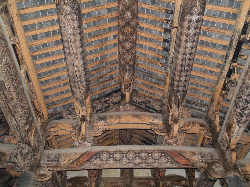 Painted wooden eaves and roof decoration on a historic building in a traditional Huizhou-style village in Anhui