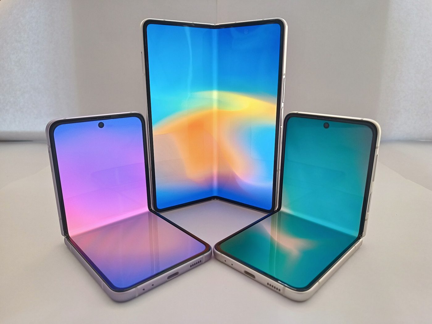 Two foldable smartphones shown side by side, one open and one closed, against a plain background.