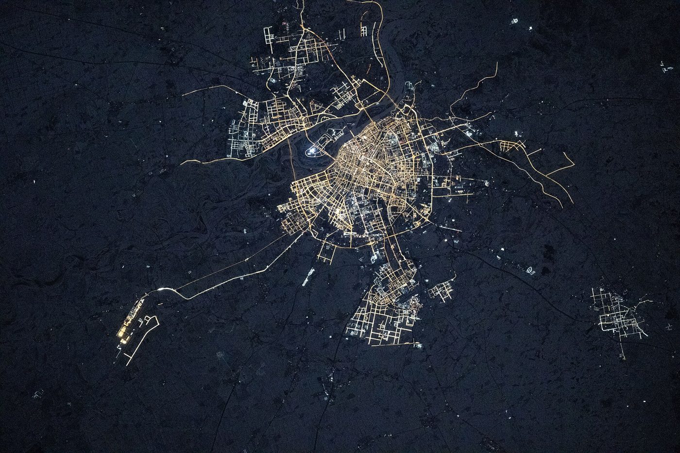 NASA satellite photo of Harbin, China, showing the frozen Songhua River winding through the city in winter