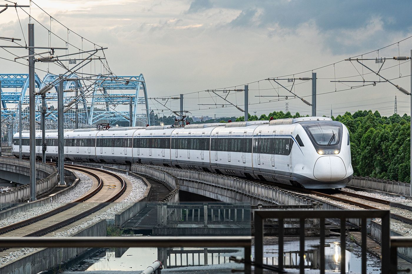 An intercity CRH6 train arrives at a station platform in China