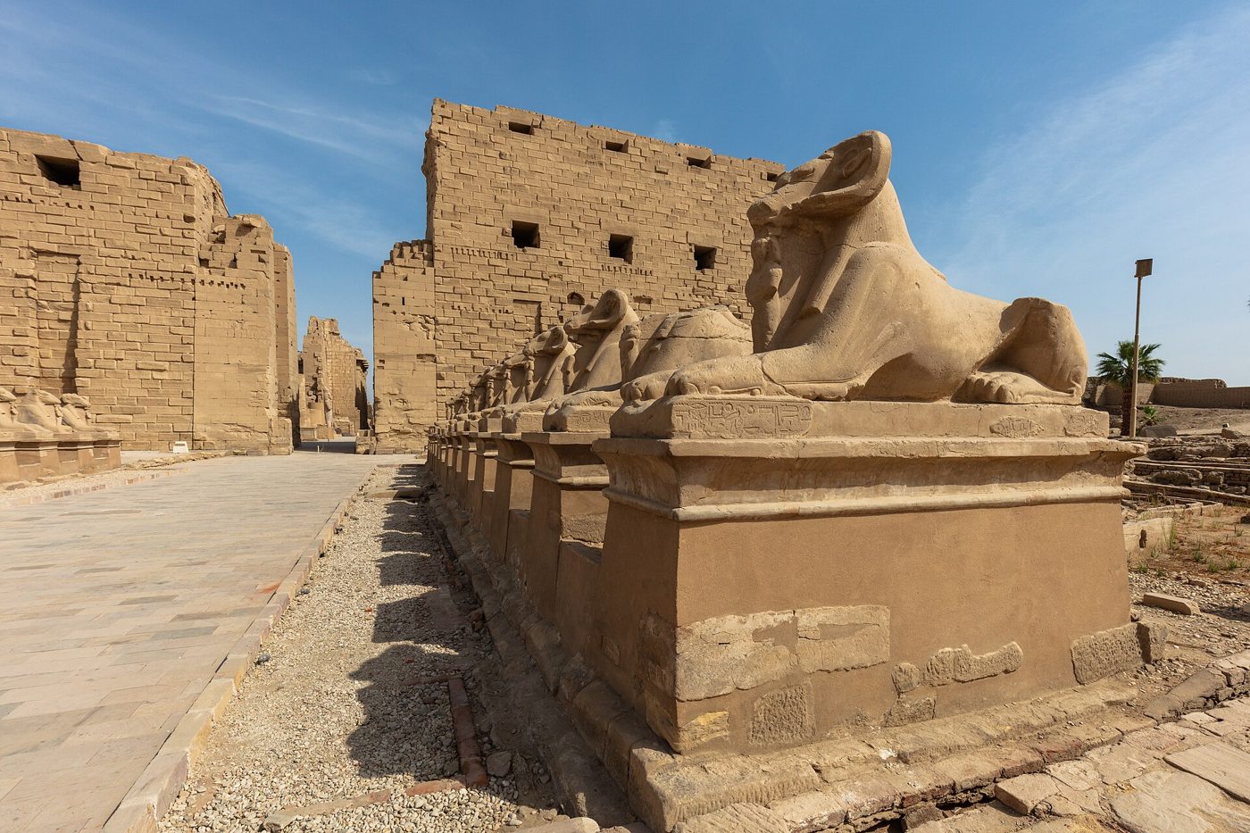 Colonnaded ruins of the Karnak temple complex at Luxor, Egypt, seen against a blue sky
