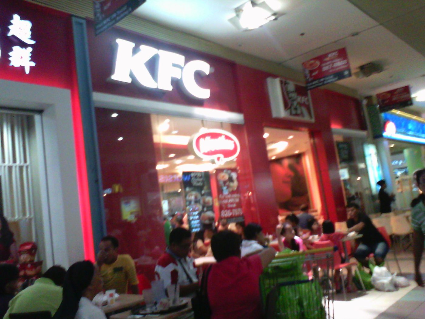 A KFC restaurant storefront with its red sign and logo.
