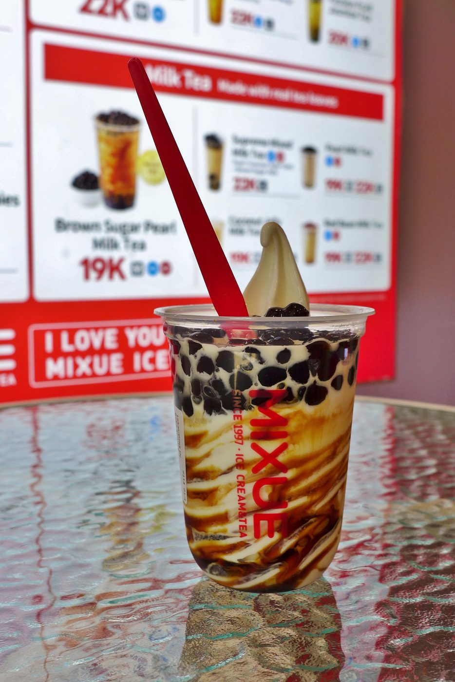 A cup of Mixue's brown sugar pearl milk tea, the chain's signature drink, served at one of its stores