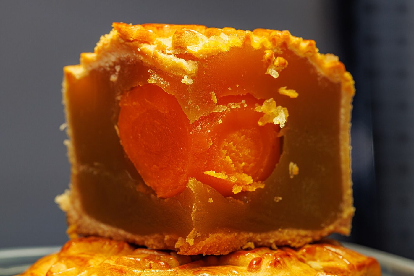 A mooncake cut open, showing the salted egg yolk in the middle