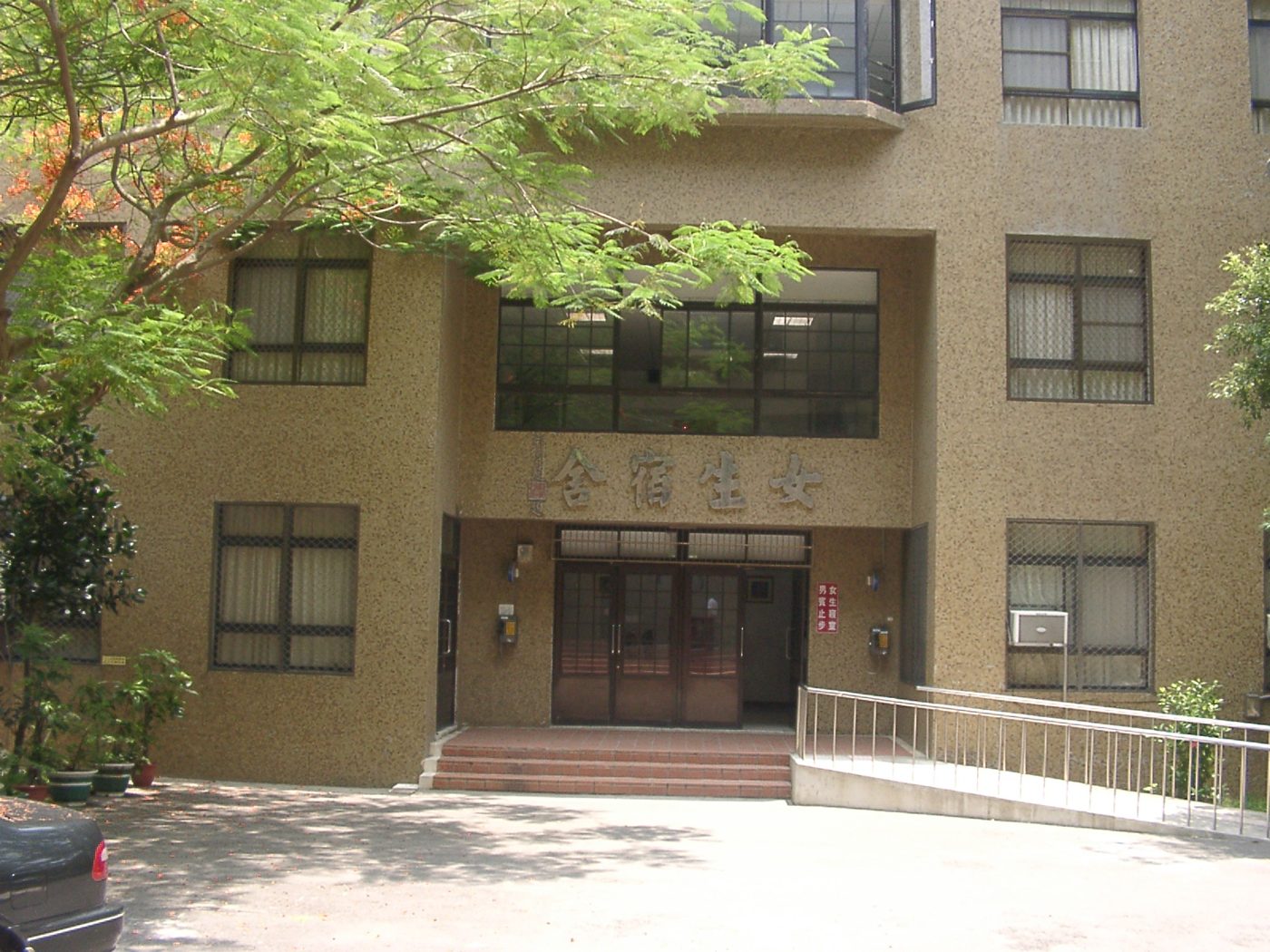 Dormitory buildings at a Chinese university, the kind of building where delivery riders leave food for students to pick up at the entrance.