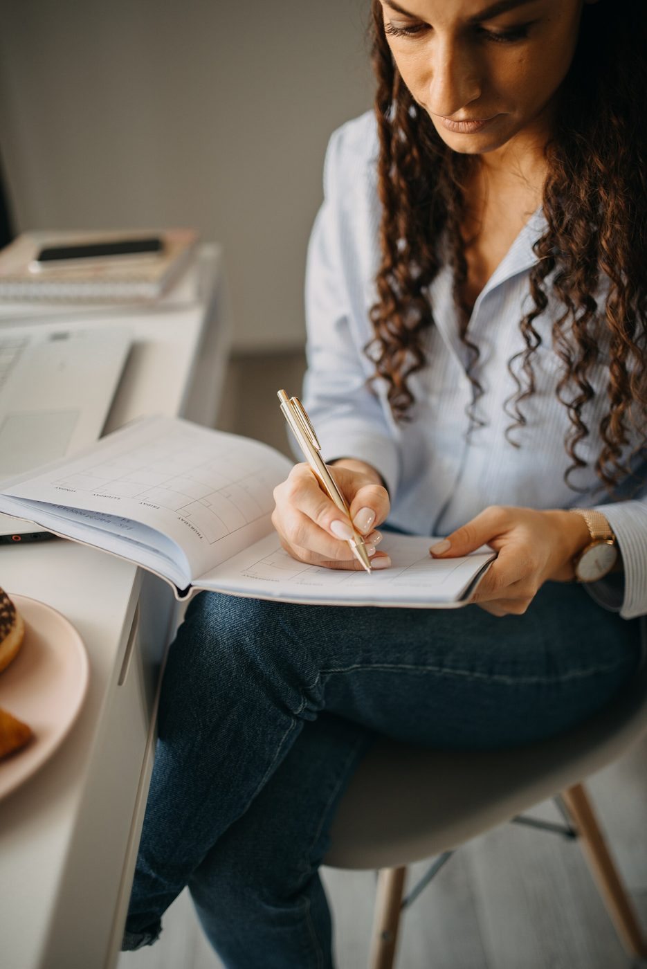 A desk with an open notebook and pen