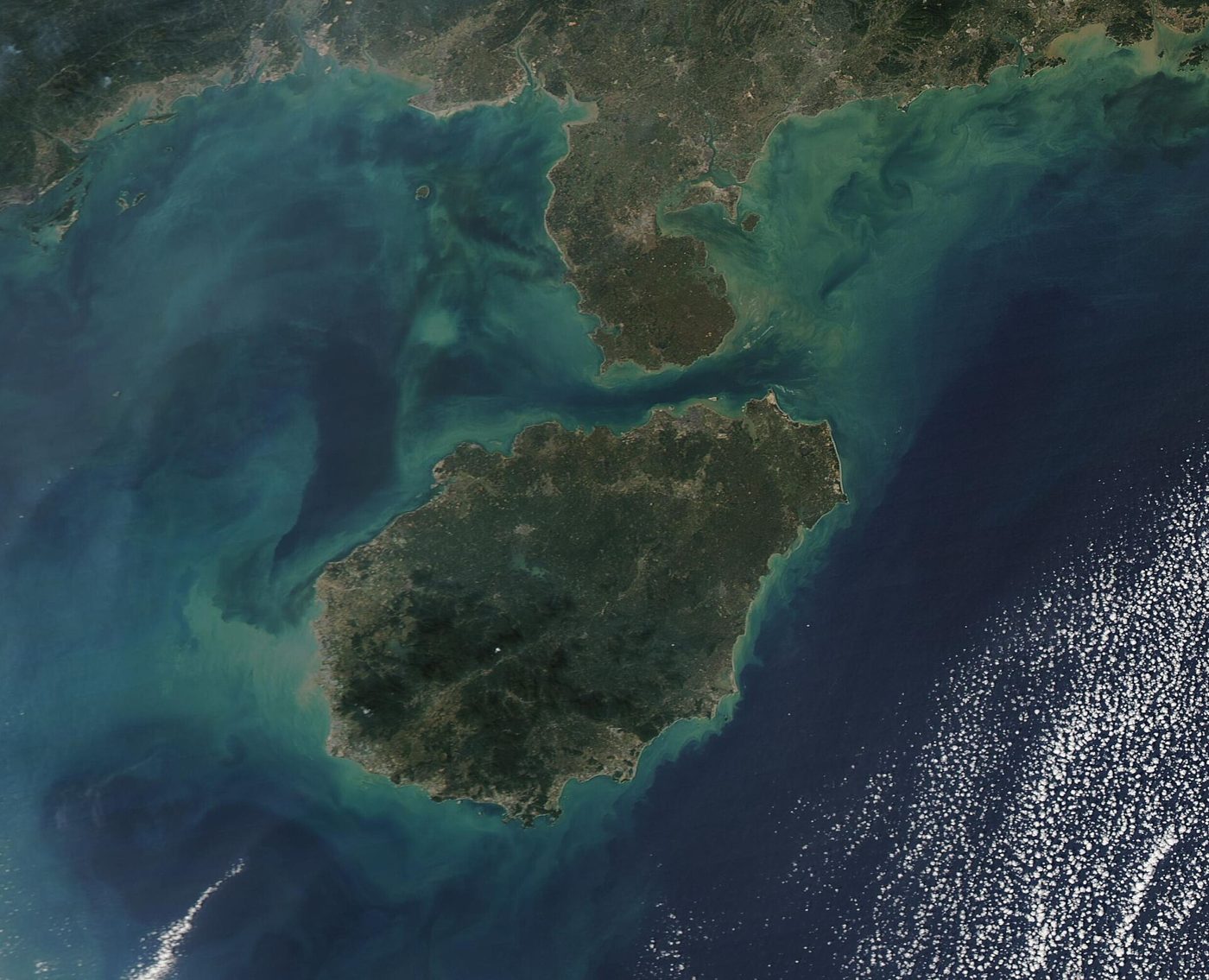Satellite image of Hainan Island and the surrounding South China Sea waters, one of the coastal areas under typhoon and rainstorm alerts.