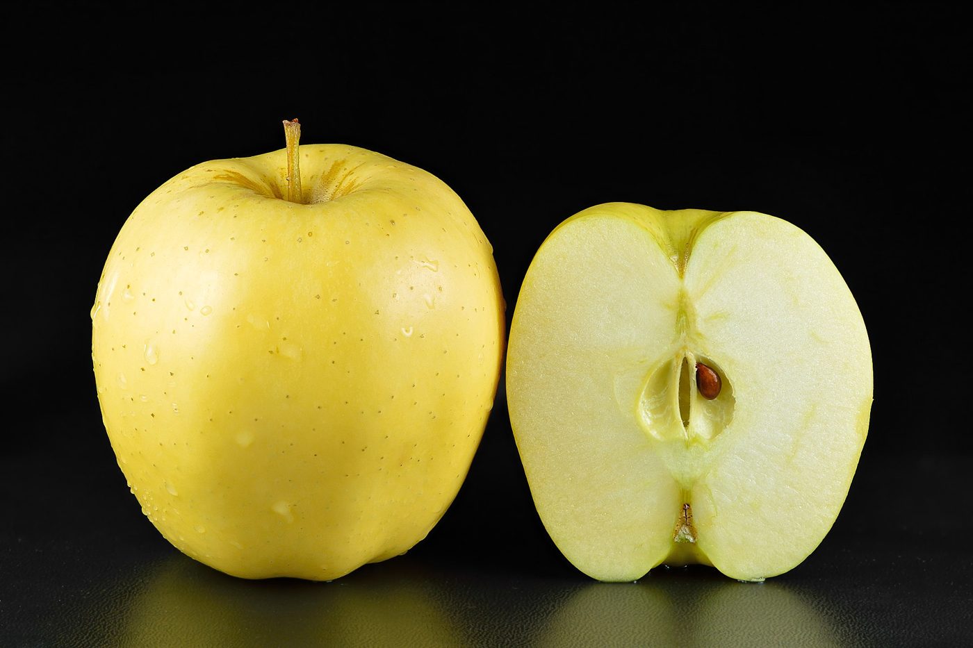 Golden apples, one of them cut in half