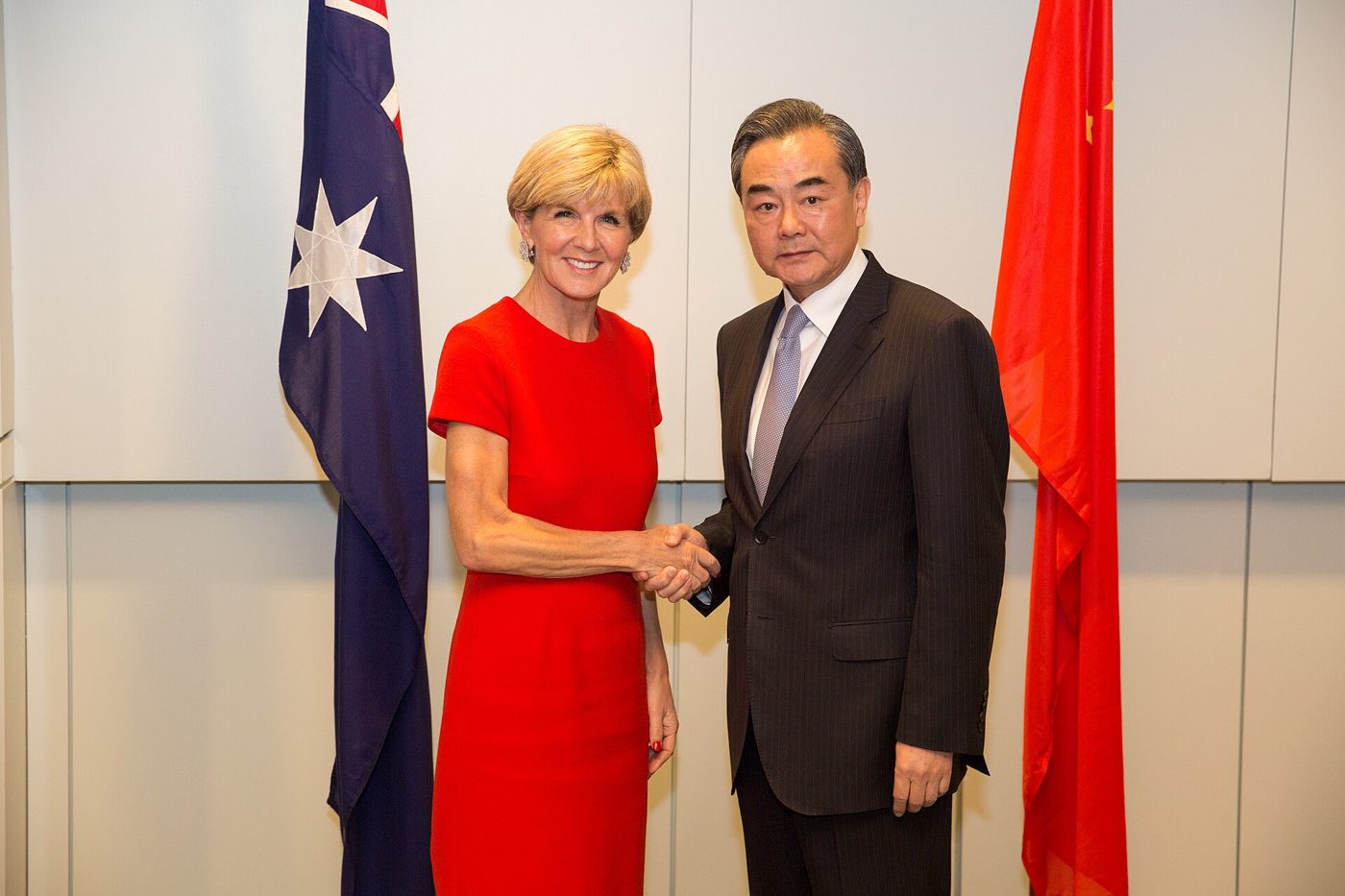 Chinese Foreign Minister Wang Yi speaking with an Australian counterpart at a diplomatic dinner